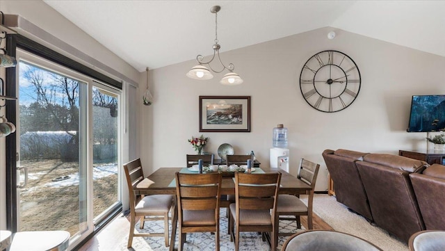 dining area with light carpet and vaulted ceiling