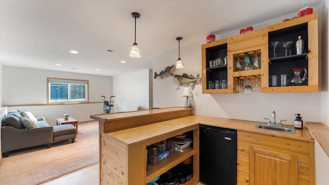 bar featuring a sink, a textured ceiling, refrigerator, indoor wet bar, and light colored carpet