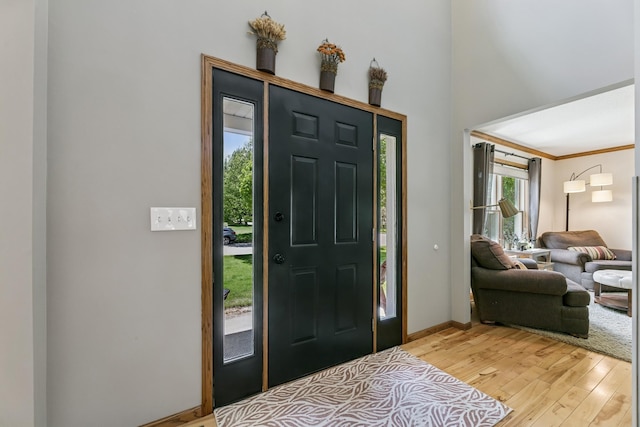 2415 Field Ct, Saint Cloud, MN 56301 - foyer entrance with light wood-style flooring, baseboards, and crown molding