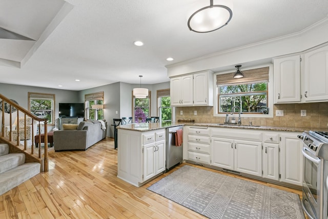 2415 Field Ct, Saint Cloud, MN 56301 - kitchen featuring appliances with stainless steel finishes, a sink, white cabinets, a peninsula, and recessed lighting