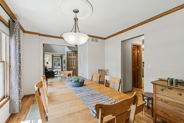 2415 Field Ct, Saint Cloud, MN 56301 - dining area featuring light wood-type flooring and crown molding