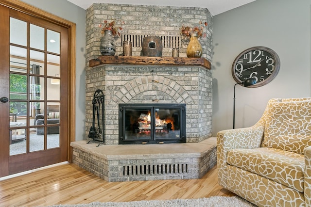 2415 Field Ct, Saint Cloud, MN 56301 - living room with a brick fireplace and wood finished floors