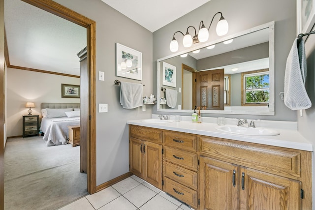 2415 Field Ct, Saint Cloud, MN 56301 - ensuite bathroom featuring double vanity, tile patterned floors, and baseboards