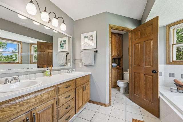 2415 Field Ct, Saint Cloud, MN 56301 - bathroom featuring double vanity, toilet, a garden tub, tile patterned flooring, and baseboards