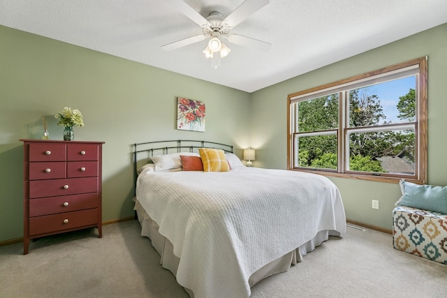 2415 Field Ct, Saint Cloud, MN 56301 - bedroom with light carpet, baseboards, and a ceiling fan