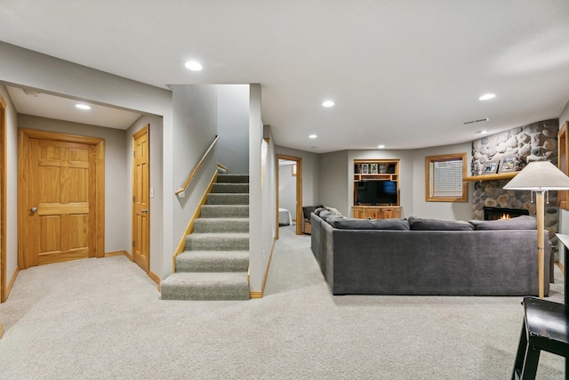 2415 Field Ct, Saint Cloud, MN 56301 - carpeted living room featuring stairway, recessed lighting, a stone fireplace, and baseboards