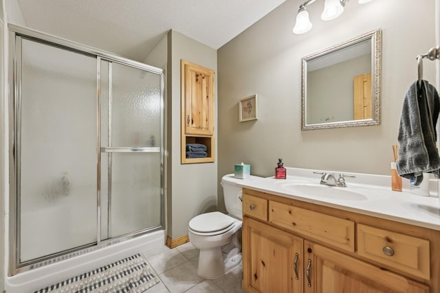 2415 Field Ct, Saint Cloud, MN 56301 - bathroom featuring toilet, vanity, a stall shower, and tile patterned flooring