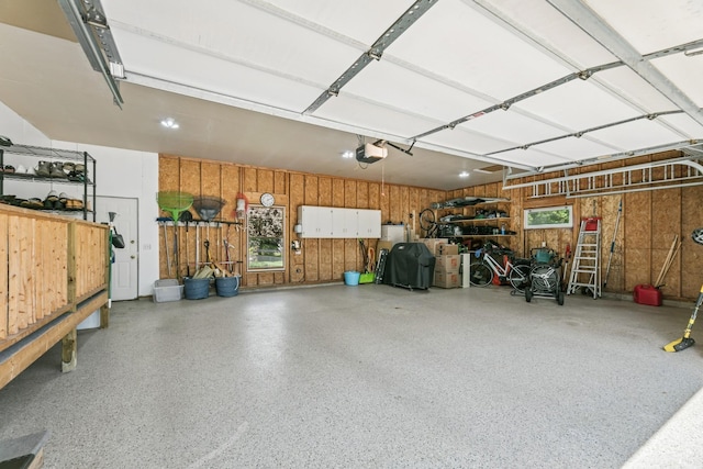 2415 Field Ct, Saint Cloud, MN 56301 - garage with wood walls and a garage door opener