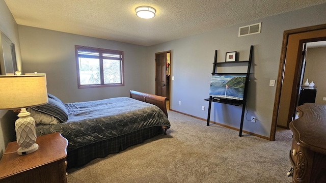 bedroom featuring visible vents, carpet flooring, a textured ceiling, and baseboards