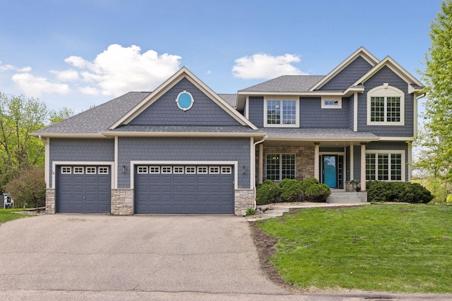 6620 Treetop Rd, Chanhassen, MN 55317 - craftsman house with stone siding, an attached garage, a front lawn, and driveway