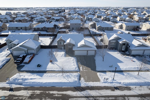 snowy aerial view featuring a residential view