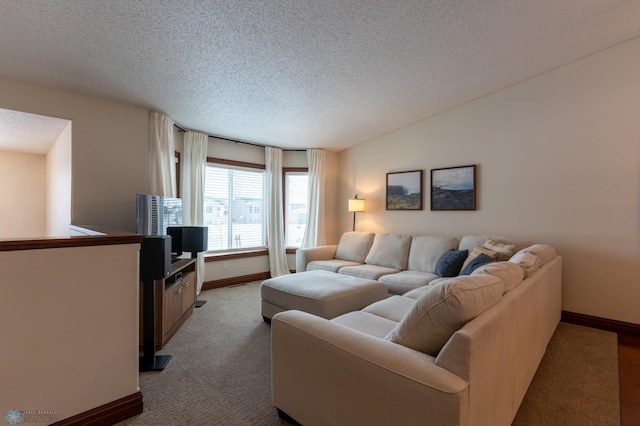 carpeted living room with a textured ceiling, lofted ceiling, and baseboards