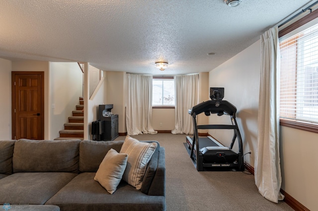 interior space featuring baseboards, a textured ceiling, and carpet flooring