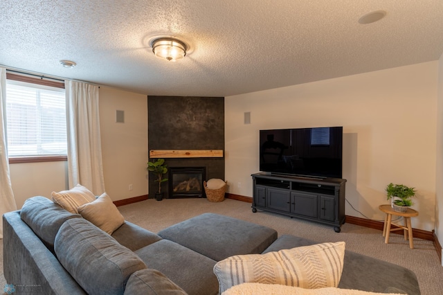 living room with a textured ceiling, light carpet, baseboards, and a large fireplace