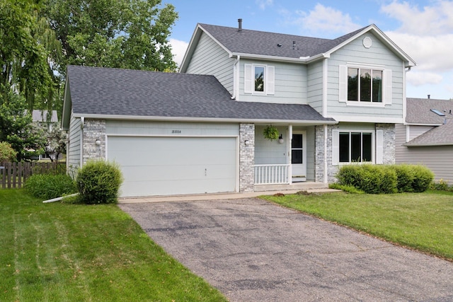 18884 Pennington Ave, Eden Prairie, MN 55346 - view of front of home with driveway, an attached garage, roof with shingles, stone siding, and a porch