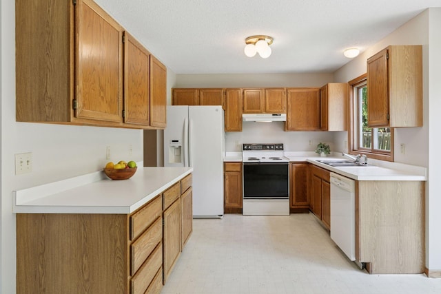 18884 Pennington Ave, Eden Prairie, MN 55346 - kitchen featuring white appliances, under cabinet range hood, light countertops, light floors, and brown cabinetry