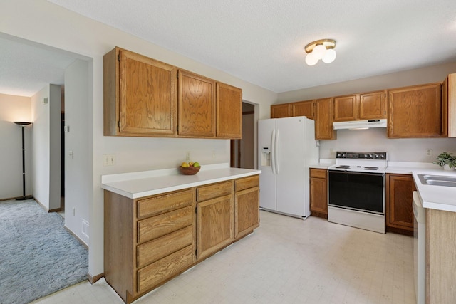 18884 Pennington Ave, Eden Prairie, MN 55346 - kitchen featuring white appliances, under cabinet range hood, light countertops, light floors, and brown cabinetry