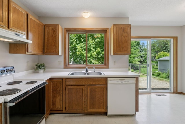 18884 Pennington Ave, Eden Prairie, MN 55346 - kitchen with white appliances, under cabinet range hood, light floors, light countertops, and a textured ceiling