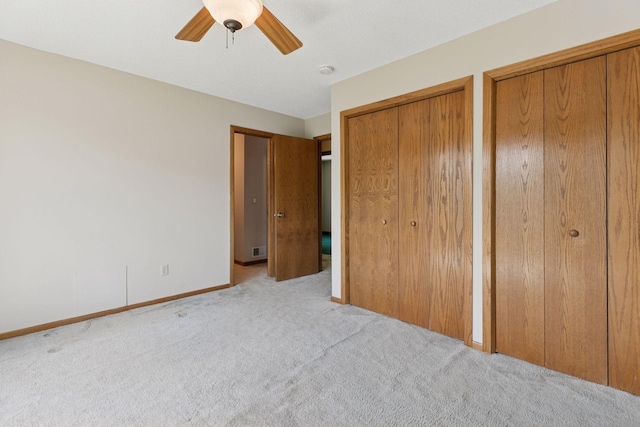 18884 Pennington Ave, Eden Prairie, MN 55346 - unfurnished bedroom featuring light colored carpet, two closets, and a ceiling fan