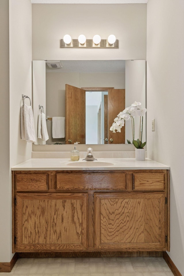 18884 Pennington Ave, Eden Prairie, MN 55346 - bathroom with vanity and baseboards