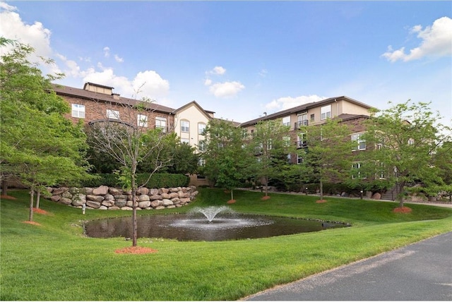 view of property's community with a lawn