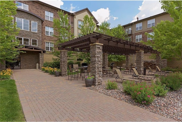 view of property's community featuring a patio area and a pergola