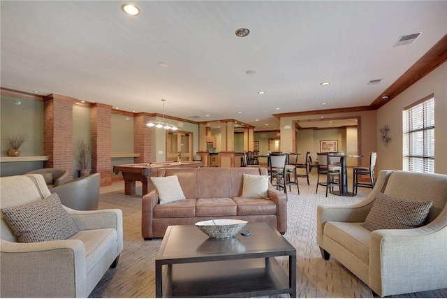 living area with crown molding, recessed lighting, and visible vents