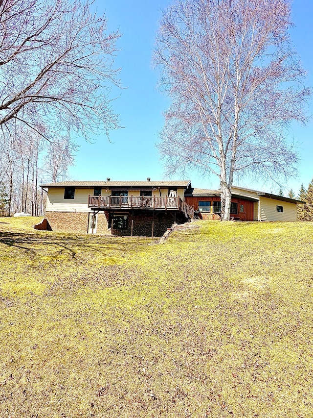 1421 Riverside Dr NW, Baudette, MN 56623 - rear view of property featuring a deck and a yard