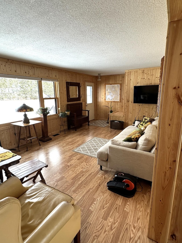 1421 Riverside Dr NW, Baudette, MN 56623 - living room with a textured ceiling, wood finished floors, and wood walls