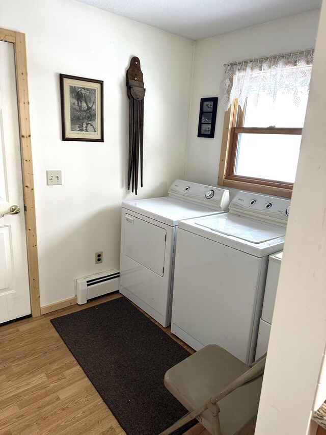 1421 Riverside Dr NW, Baudette, MN 56623 - laundry room with washing machine and clothes dryer, baseboard heating, and light wood-style floors