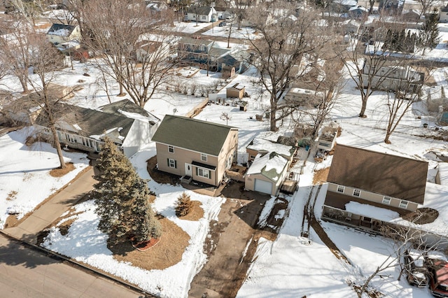 snowy aerial view with a residential view