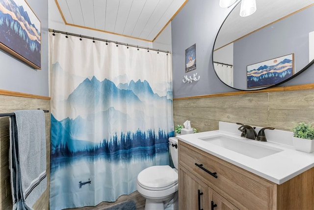 full bathroom with wainscoting, curtained shower, toilet, and vanity