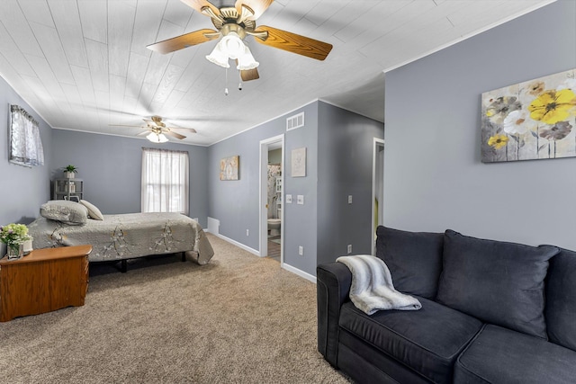 carpeted bedroom with ceiling fan, baseboards, visible vents, and ornamental molding