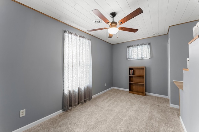 unfurnished room featuring visible vents, baseboards, ceiling fan, and carpet floors