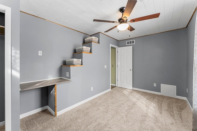 interior space featuring visible vents, baseboards, and a ceiling fan