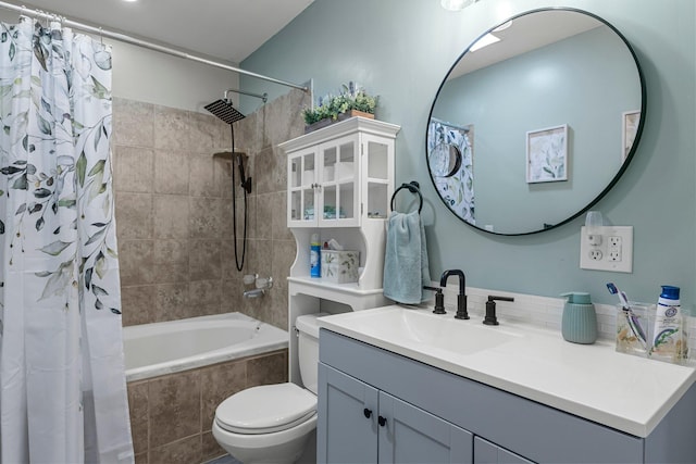 bathroom featuring vanity, toilet, and tiled shower / bath combo