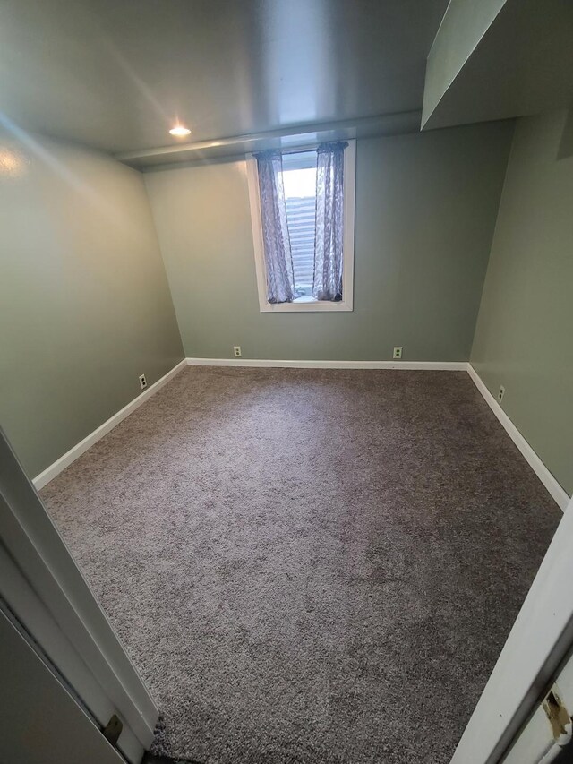 carpeted spare room with baseboards