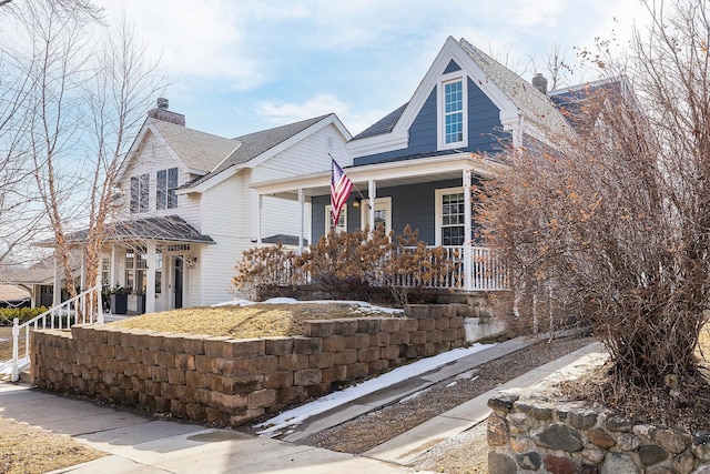 view of front of home with a porch and a chimney