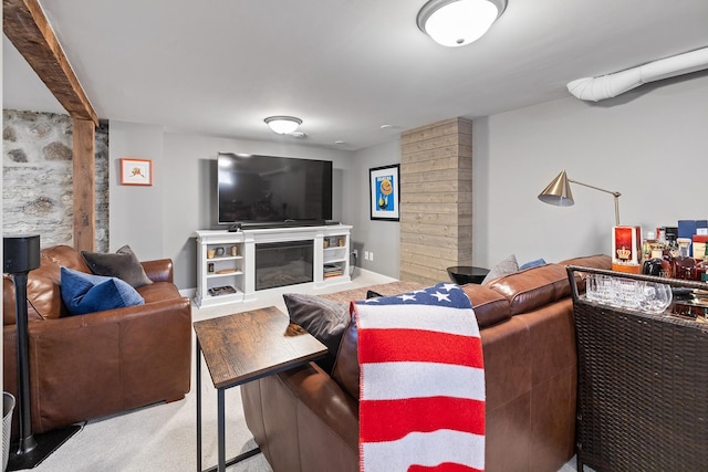 living room featuring a glass covered fireplace and carpet