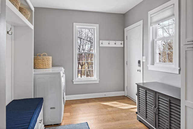 mudroom with baseboards, a healthy amount of sunlight, and light wood-style flooring