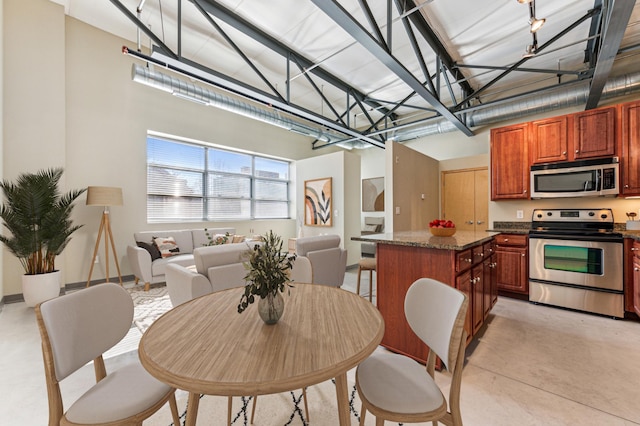 dining space featuring concrete floors