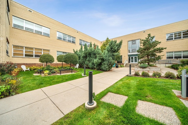 surrounding community with entry steps and a yard