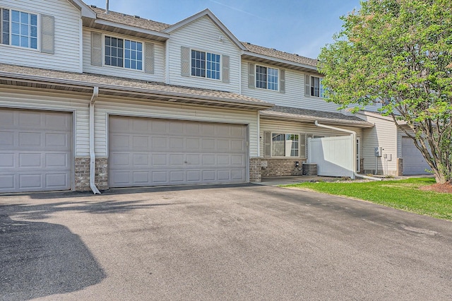 16786 Embers Ave, Lakeville, MN 55024 - multi unit property featuring a garage, brick siding, asphalt driveway, central air condition unit, and a shingled roof