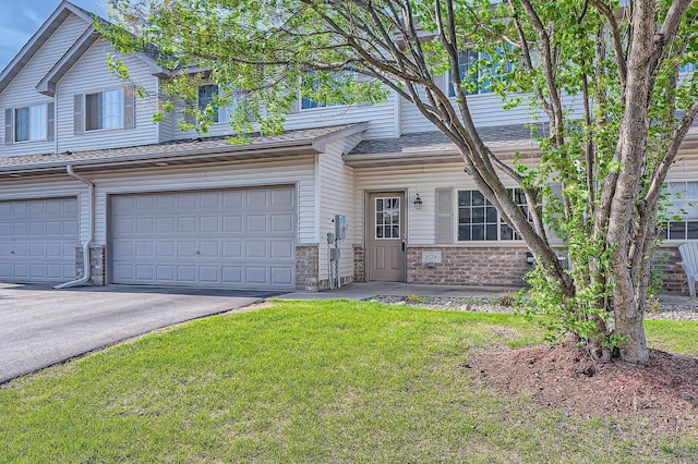 16786 Embers Ave, Lakeville, MN 55024 - view of property with a front lawn, a garage, driveway, and brick siding