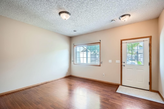 16786 Embers Ave, Lakeville, MN 55024 - foyer entrance with healthy amount of natural light, wood finished floors, baseboards, and a textured ceiling