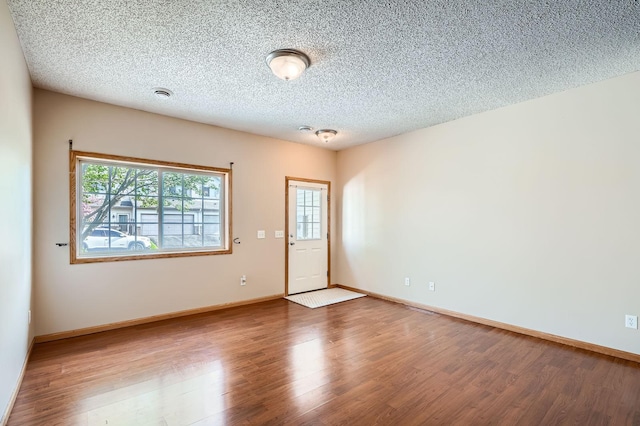 16786 Embers Ave, Lakeville, MN 55024 - spare room with plenty of natural light, wood finished floors, a textured ceiling, and baseboards