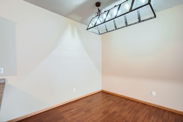 16786 Embers Ave, Lakeville, MN 55024 - unfurnished dining area with a textured ceiling, wood finished floors, and baseboards