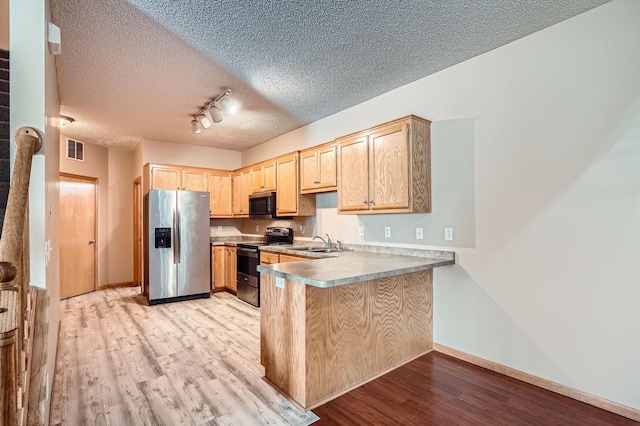 16786 Embers Ave, Lakeville, MN 55024 - kitchen featuring stainless steel appliances, light brown cabinets, a peninsula, light wood-style flooring, and a sink