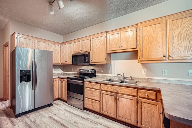 16786 Embers Ave, Lakeville, MN 55024 - kitchen featuring stainless steel appliances, a sink, light wood-style floors, a textured ceiling, and light countertops