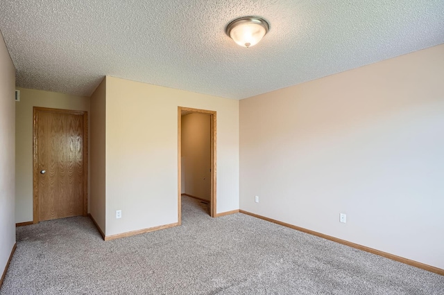 16786 Embers Ave, Lakeville, MN 55024 - unfurnished bedroom featuring light carpet, a textured ceiling, and baseboards